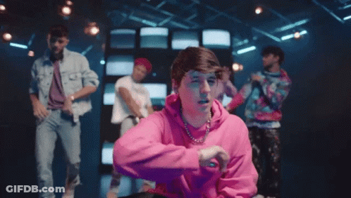 Man In Pink Hoodie Making Peace Sign Dancing GIF