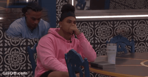 Man In Pink Hoodie Sits In Chair GIF