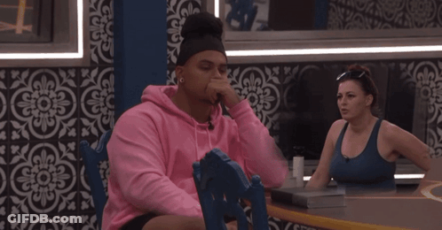 Man In Pink Hoodie Sitting At Table GIF