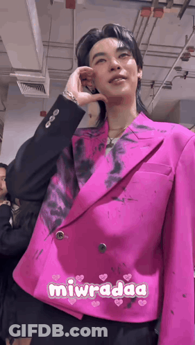 Man In Pink Jacket And Black Pants Standing With Others GIF
