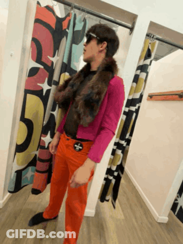 Man In Pink Jacket And Orange Pants In Changing Room GIF
