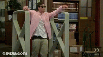 Man In Pink Jacket And Sunglasses By Giant Tape Dispenser GIF