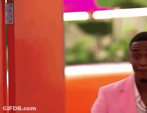 Man In Pink Jacket At Orange Door GIF