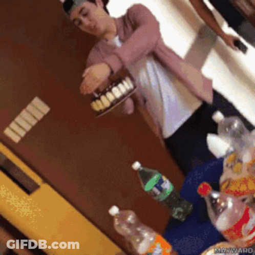 Man In Pink Jacket Holding Coca Cola Cake GIF