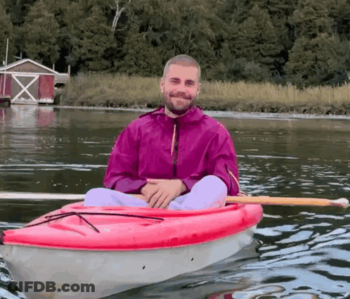 Man In Pink Jacket In Red Kayak GIF