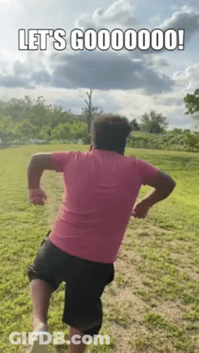 Man In Pink Shirt And Black Shorts Running GIF