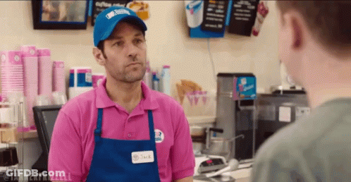 Man In Pink Shirt And Blue Apron Talking GIF