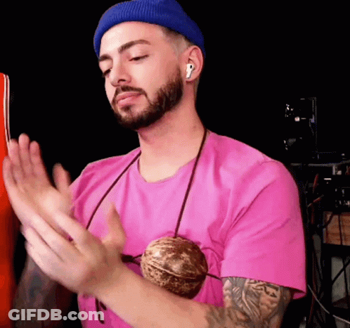 Man In Pink Shirt And Blue Beanie Clapping GIF