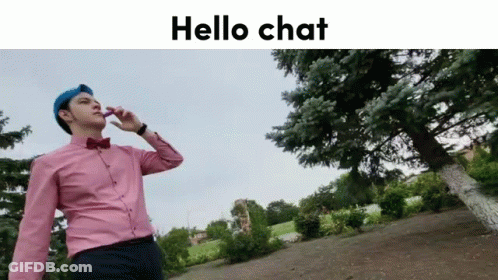 Man In Pink Shirt And Blue Hat Talking On Cell Phone In Front Of Tree GIF
