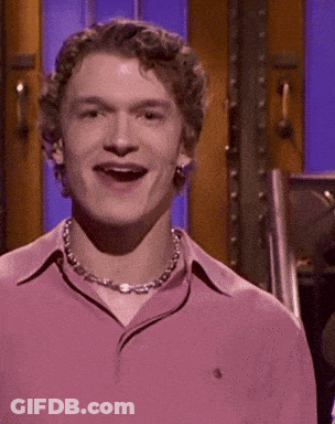 Man In Pink Shirt And Chain Smiling GIF