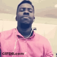 Man In Pink Shirt And Headphones Making Face GIF