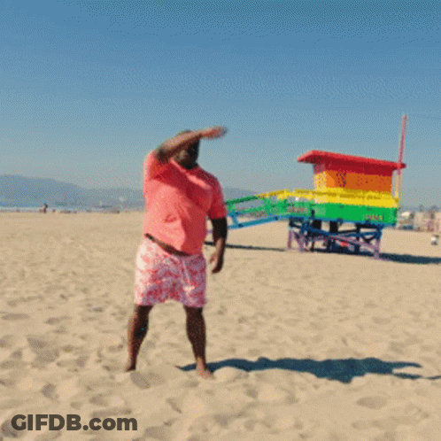 Man In Pink Shirt And Shorts On Beach GIF