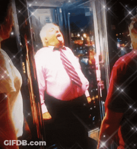 Man In Pink Shirt And Tie In Front Of Glass Door GIF