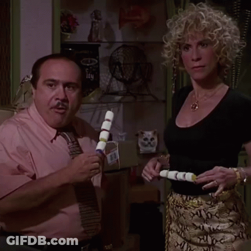 Man In Pink Shirt And Tie Next To Blonde Woman GIF