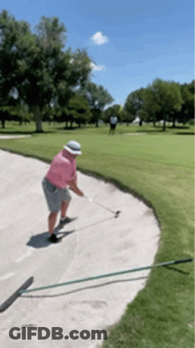Man In Pink Shirt And White Hat Swinging Golf Club GIF
