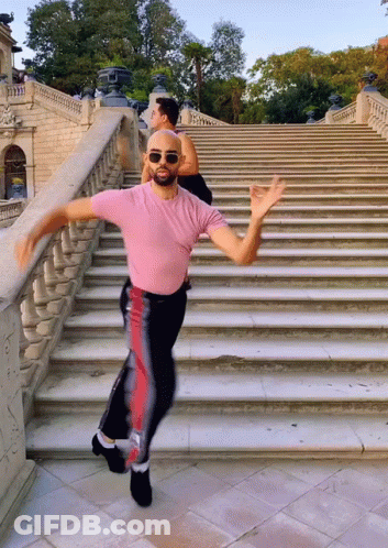Man In Pink Shirt Dancing On Stairs GIF