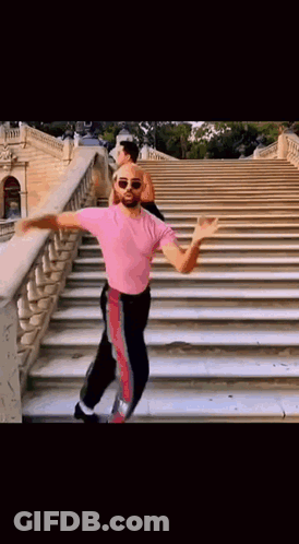 Man In Pink Shirt Dancing On Stairs GIF