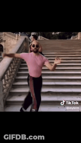 Man In Pink Shirt Dancing On Steps GIF
