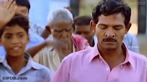 Man In Pink Shirt Eyes Closed In Front Of Crowd GIF