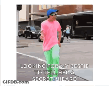 Man In Pink Shirt Green Pants Telling Secret GIF