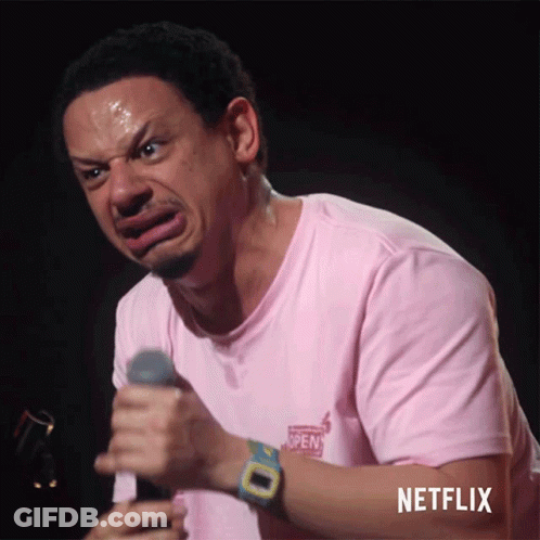 Man In Pink Shirt Holding Microphone With Netflix Logo GIF