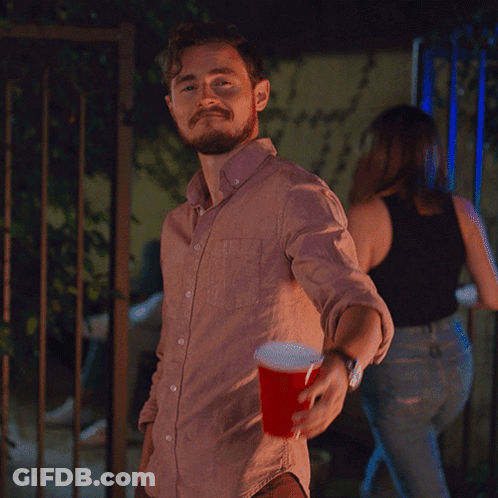 Man In Pink Shirt Holding Red Cup GIF