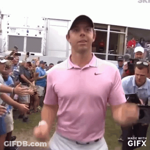 Man In Pink Shirt In Front Of Crowd GIF
