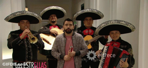 Man In Pink Shirt In Front Of Mariachi Band GIF
