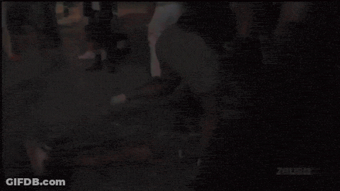 Man In Pink Shirt In Front Of Zous Wall GIF
