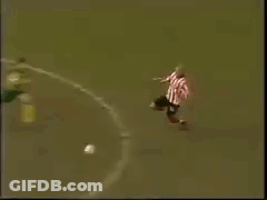 Man In Pink Shirt Lying Before Goalie GIF