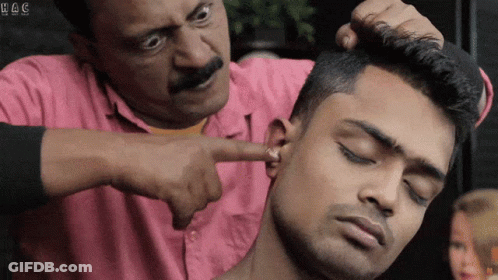 Man In Pink Shirt Pointing At Ear With H & C GIF