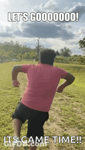 Man In Pink Shirt Running In Field GIF