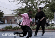Man In Pink Shirt Running With Woman In Black Sweater GIF