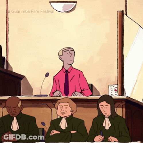 Man In Pink Shirt Sitting At Judge Desk GIF