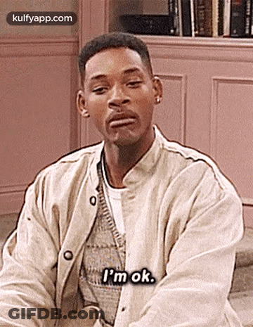 Man In Pink Shirt Sitting On Couch GIF