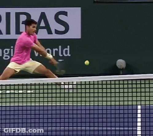 Man In Pink Shirt Swinging Tennis Racquet GIF