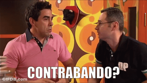 Man In Pink Shirt Talking To Man In Green And Black Striped Sweater GIF