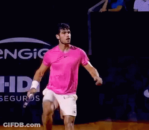 Man In Pink Shirt, White Shorts Holding Tennis Racquet GIF