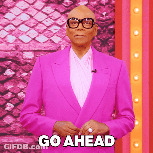 Man In Pink Suit And Glasses Says Go Ahead GIF