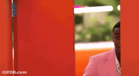 Man In Pink Suit At Red Door GIF