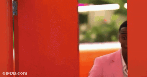 Man In Pink Suit At Red Door GIF