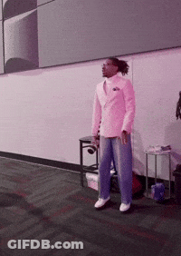Man In Pink Suit In Front Of Pink Wall GIF