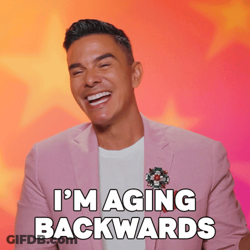 Man In Pink Suit Laughing I'm Aging Backwards GIF