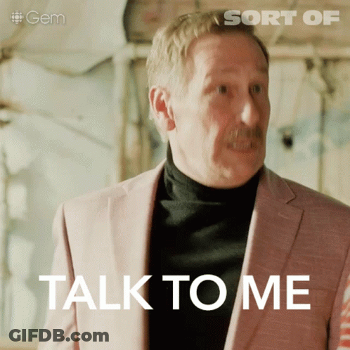 Man In Pink Suit Saying Talk To Me GIF