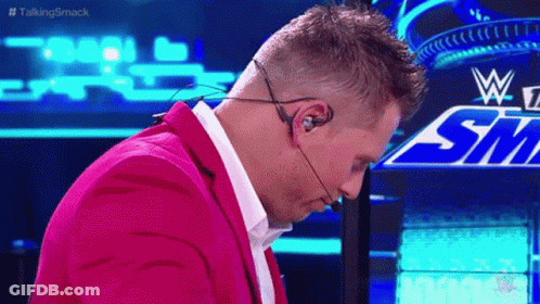 Man In Pink Suit Wearing Headset GIF