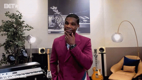 Man In Pink Suit With BET Logo Behind Him GIF