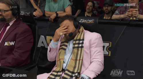 Man In Pink Suit With Zipchair Sign GIF