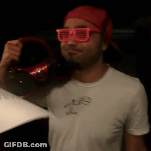 Man In Pink Sunglasses And Red Hat Holding Headphones GIF