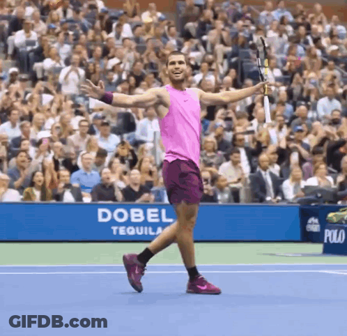 Man In Pink Tank Top Holding Tennis Racquet In Front Of Dobel Tequila Banner GIF