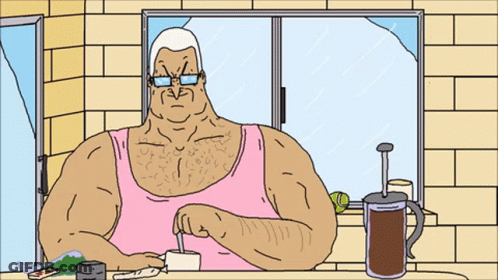 Man In Pink Tank Top Sitting At Table GIF